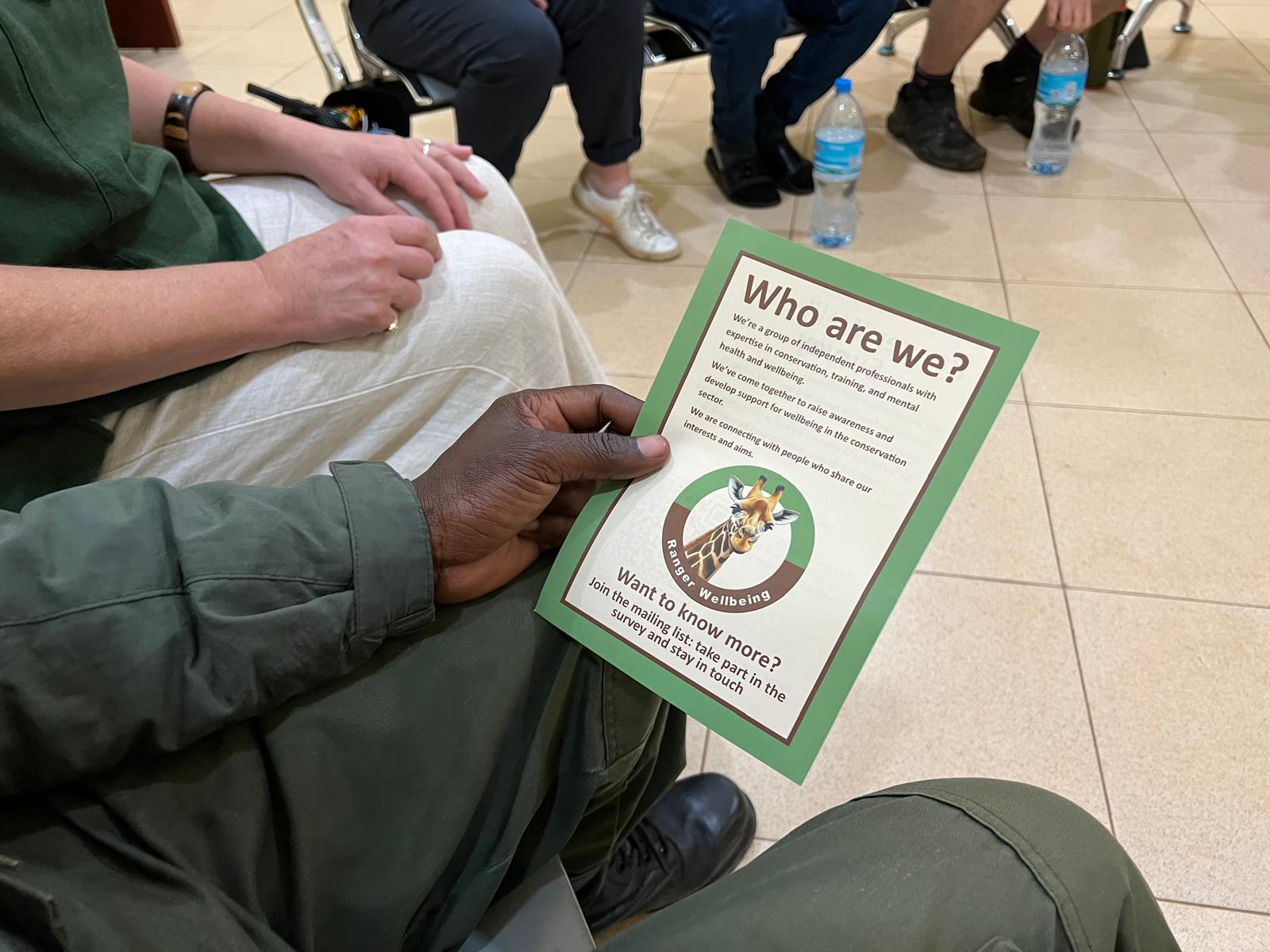 Ranger holding an awareness leaflet explaining what we do